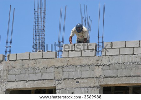 Construction worker on a concrete block wall project