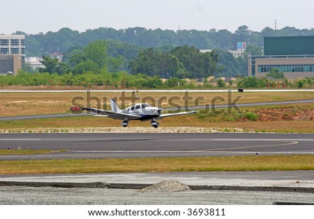 An airplane with wheels inches above the runway