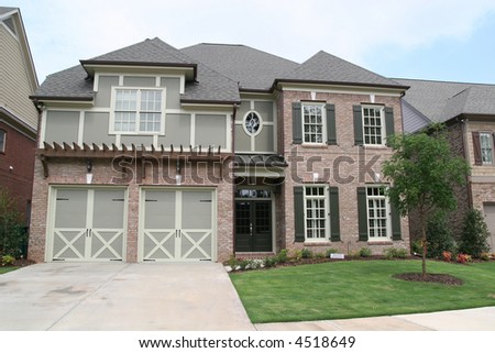 A traditional brick two story house and lawn
