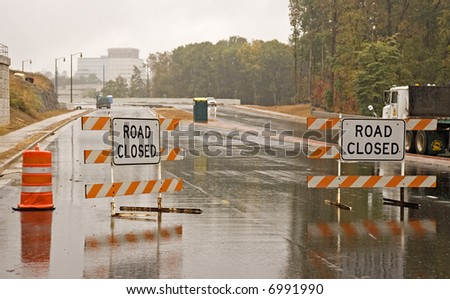 Road closed for bridge construction in the rain