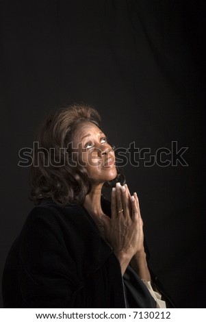 A spiritual  woman looking to heaven and praying
