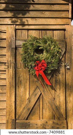 A Christmas wreath on an old barn door