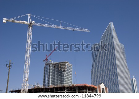 An urban construction scene with cranes and new office towers