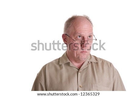 An older guy in a brown shirt looking up over his glasses