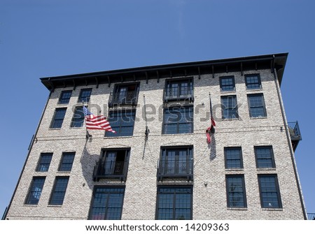 Modern loft building in a classic architecture style with american flags out front