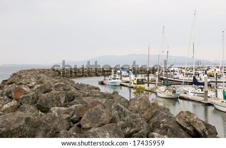 A stone sea wall around a fishing harbor
