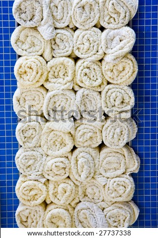Rolled towels in a tile cabinet at a spa or pool
