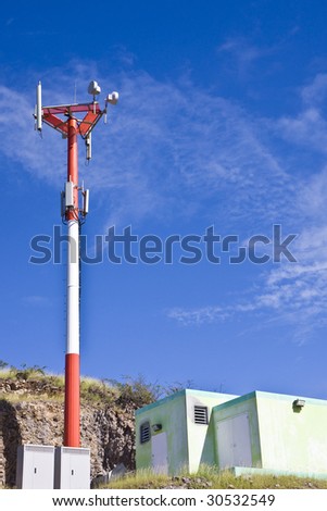 A cellular telephone tower against a blue sky