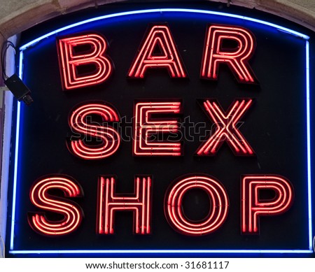 A neon sign outside a sex shop and bar