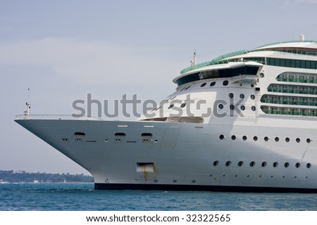 The bow of a large cruise ship anchored in the bay