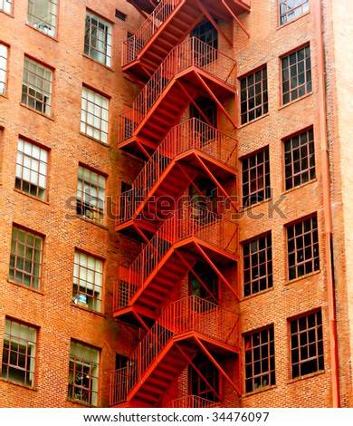 A an old red fire escape on a brick building