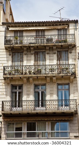 An old apartment or condo building in france with shutters and balconies