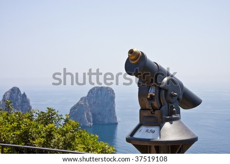 An old fashioned coin operated telescope on the cliff overlooking the sea by Capri