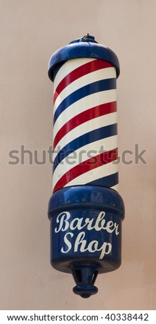 An old fashioned barber pole outside a shop