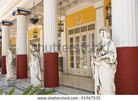 Statues and columns outside an ancient Greek palace