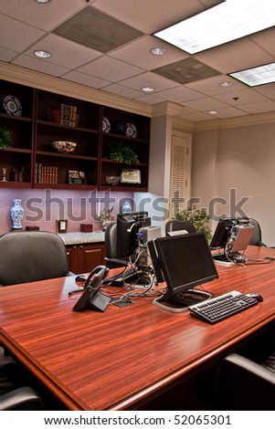 Computers set up for training on a conference room table