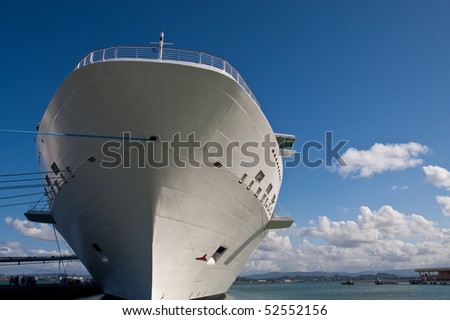 A giant white luxury cruise ship rising into a blue sky