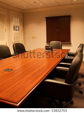 A large empty conference rooms with table and chairs