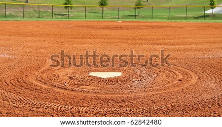 Home plate in graded dirt at a local baseball field