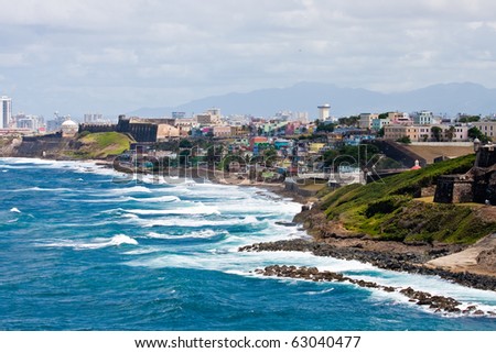 Colorful houses and buildings on the coast of Puerto Rico with a pounding surf.