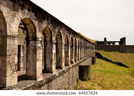 A line of old stone arches on a hilltop fortress