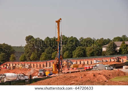 Pile driver and construction equipment at dig site
