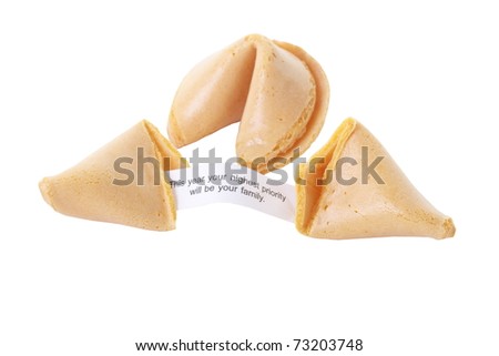 A whole fortune cookie and one split open showing fortune on white background