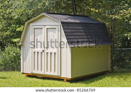 A wood utility shed in a back yard