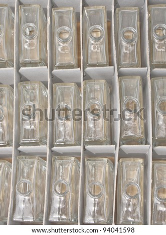 A box full of empty perfume bottles at a factory