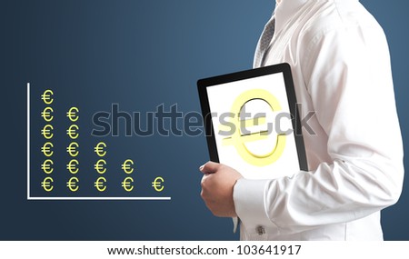 Business man holding tablet PC with Euro currency sign on screen with Euro currency chart in background. Concept for Europe economic crisis.
