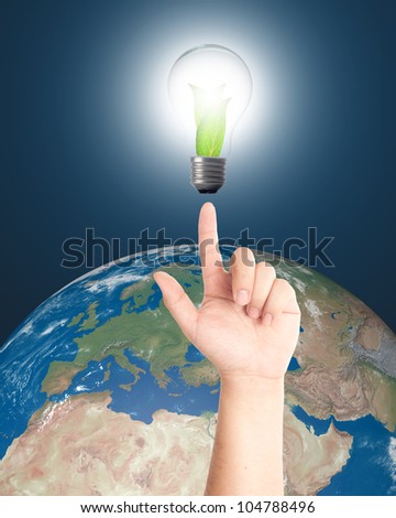 Hand pointing Light bulb with realistic earth in background. Elements of this image furnished by NASA.