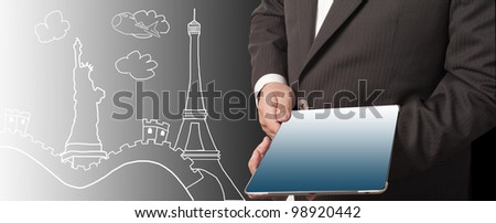 Business man showing tablet PC with world landmark in background