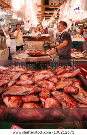 TOKYO - JULY 17 : Fish seller at Tsukiji Market, the biggest wholesale market in Japan, market will  be moved to new location in 2014, July 17, 2008 in Tokyo, Japan.