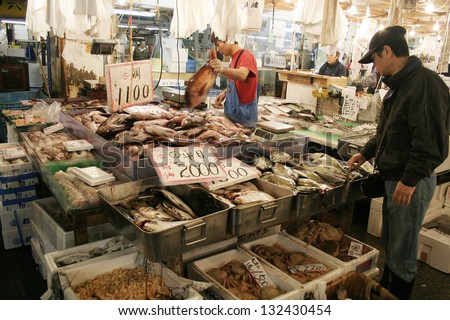 TOKYO - APRIL 13 : Fish seller at Tsukiji Market, the biggest wholesale market in Japan, market will be moved to new location in 2014, April 13, 2006 in Tokyo, Japan.