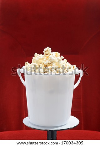 close up of popcorn bucket made of plastic over red background