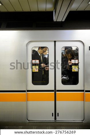 TOKYO, JAPAN - APRIL 8 : People in subway train in rush hour taken April 8, 2013. People in Tokyo use subway underground as main transportation.