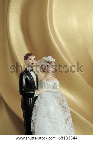 stock photo wedding couple doll on gold background