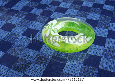 green life saver in blue swimming pool