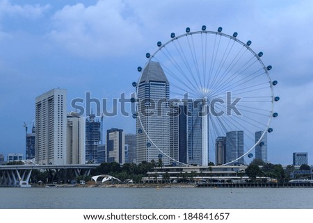 Singapore - February 14, 2014: View from distance to Singapore Flyer, huge ferries wheel and famous hotel and casino at Bayfront of Singapore.  is round about 200 meters high and 340 meters wide.