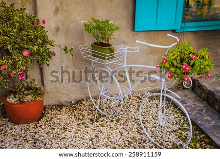 Bicycle With Flowers Basket In Garden