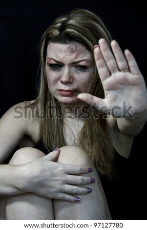 STOP Violence With Women, Scared and beaten white woman holding out her hands in the 