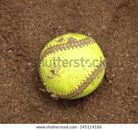 Yellow Softball on wet sand