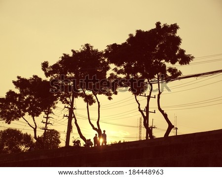silhouette of trees and people, vintage color background