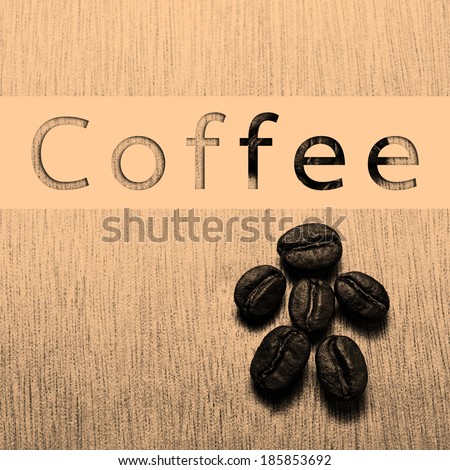 Coffee word banner with  with Roasted Coffee Beans on wood texture table, monotone color background