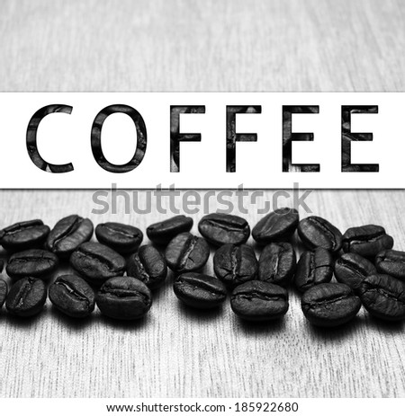 Coffee banner and Roasted Coffee Beans on wood texture table, monotone color