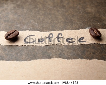 Coffee crop beans with paper on wood texture background