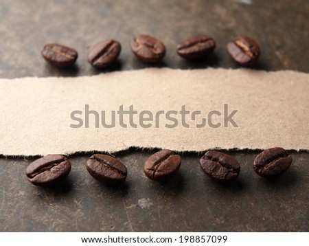 Coffee crop beans with paper on wood texture background