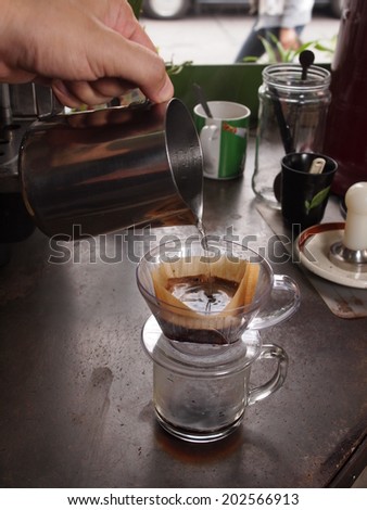 Cup of Dripping fresh hot coffee, pouring hot water to blended coffee on paper filter