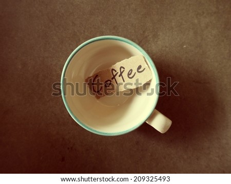 Coffee crop beans with text paper on wood texture, vintage color background