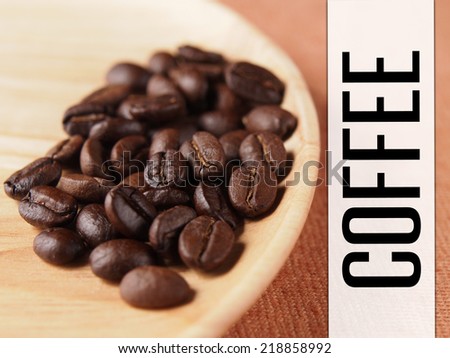 Coffee crop beans with coffee banner label on wood plate and fabric texture background